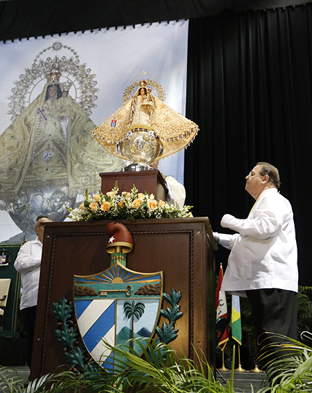 Rogelio Zelada had an immense devotion to Our Lady of Charity, patroness of Cuba, whose image he faithfully cared for throughout three decades. Here he is seen securing the image on its pedestal at the start of the annual celebration Sept. 8, 2015.