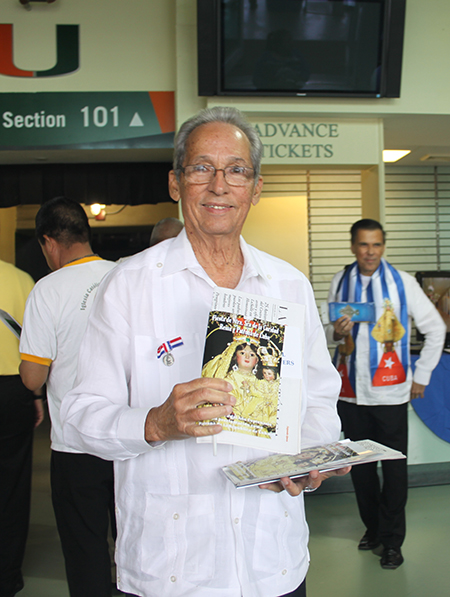 Antonio Larosa, member of the Archdiocesan Confraternity of Our Lady of Charity, hands out programs during one of the annual celebrations of the feast day of Cuba's patroness, Sept. 8.