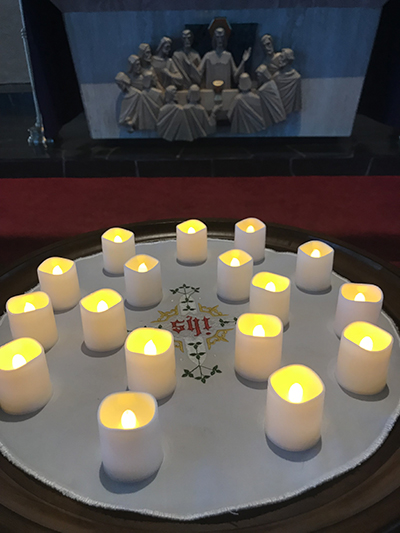 Seventeen candles -- one for each of those killed during the mass shooting at Marjory Stoneman Douglas School -- are placed before the altar at St. Jerome Church during a memorial service in 2018.