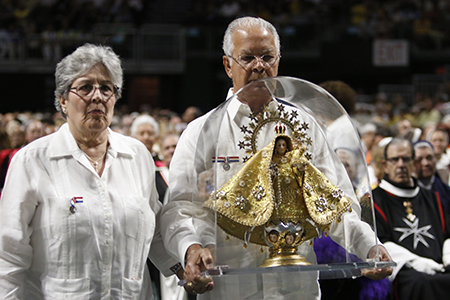 Volunteeers with the Shrine of Our Lady of Charity carry a replica of the image, made by Rogelio Zelada, which was raffled off during the Mass on the feast of Our Lady of Charity.