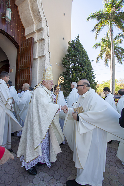 Archbishop Thomas Wenski greets priests as they enter St. Mary Cathedral during the annual Mass of chrism, celebrated the Tuesday of Holy Week, April 16, 2019.