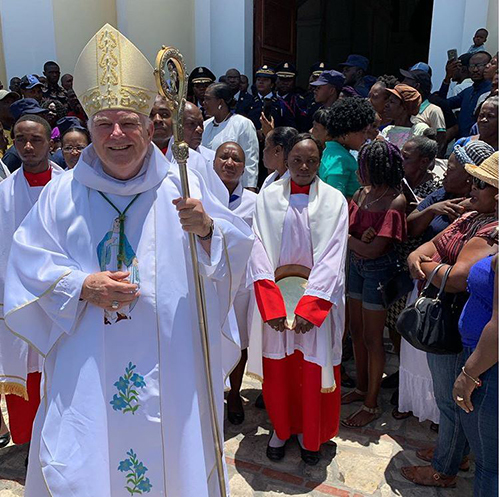 Archbishop Thomas Wenski exits the cathedral of Cap Haitien after celebrating Mass there on the feast of the Assumption, patroness of the Haitian archdiocese.