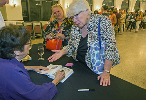 Beverly Ross, a former hospice chaplain, talks to Sister Helen Prejean as she signs her new book after her talk.