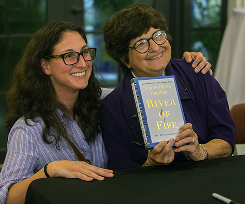 Courtney Munoz poses for a photo with Sister Helen Prejean during the book signing.
