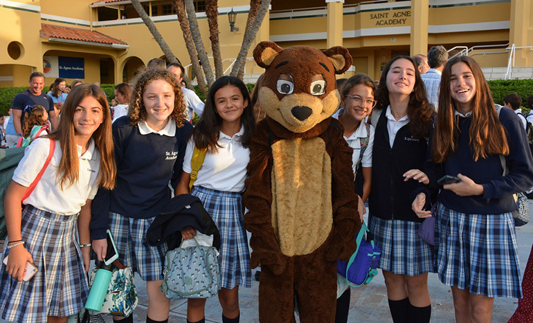 St. Agnes eighth graders, from left, Delfina Pellegrini, Maria Trapani, Maria Paz Escallon, Andrea Montaner, Nicole Beteta and Ines Saudino pose with the school's mascot, Nathan the Bear.