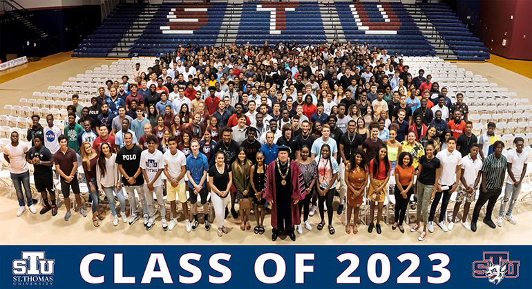 St. Thomas University President David Armstrong, center front, poses with members of the incoming freshman class after their induction ceremony Aug. 23. Due to the unprecedented size of this incoming class - 677 new undergraduate students, more than double last year's enrollment, including 555 freshmen - the formal ceremony was moved to the university's athletic center.