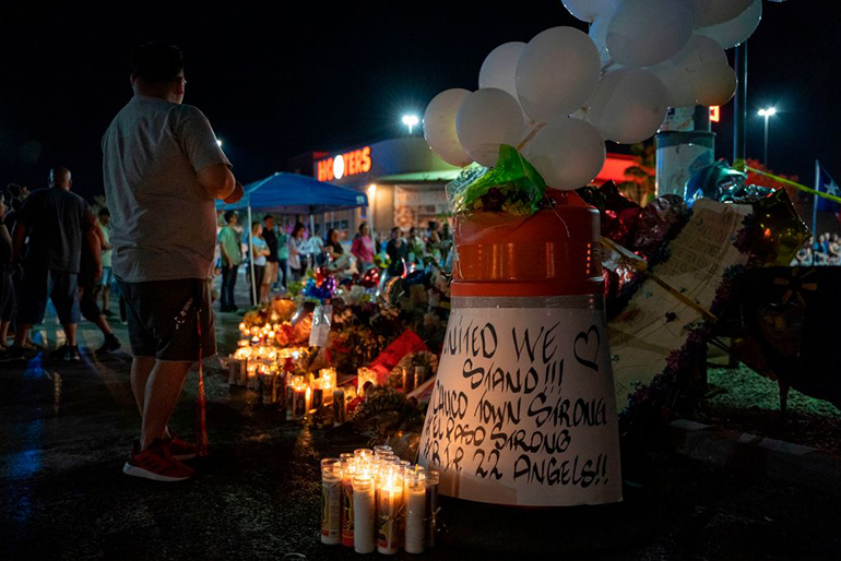 Locals of El Paso visit the memorial for shooting victims at the Cielo Vista Mall Walmart in El Paso, Texas on August 8, 2019. The El Paso community is still reeling from the trauma of the mass shooting which left 22 dead and dozens injured.