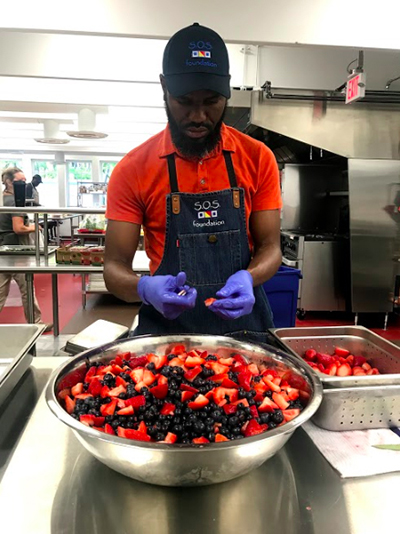 Seminarian Dieutan Marseille helps with food preparation at the SOS Callahan Community Kitchen, one of several outreach programs sponsored by the Basilica of St. Mary Star of the Sea in Key West. He was one of four seminarians who helped at the parish ministries last summer.