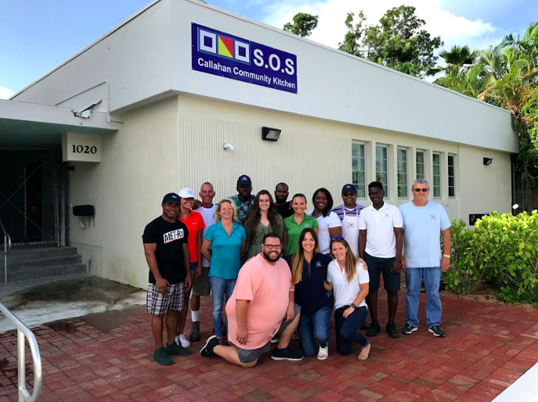 Volunteers and staff, including four archdiocesan seminarians, pose for a photo outside the SOS Callahan Community Kitchen, one of several outreach programs sponsored by the Basilica of St. Mary Star of the Sea in Key West. The kitchen, located behind Key West's city hall, was dedicated in December 2018.