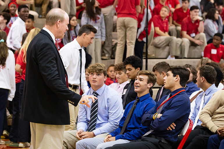 Thomas E. Mahon, president of Cardinal Gibbons High School in Fort Lauderdale, speaks to students before the start of a Mass for the opening of the new school year Aug. 22. Archbishop Thomas Wenski president at the liturgy at the school's campus.