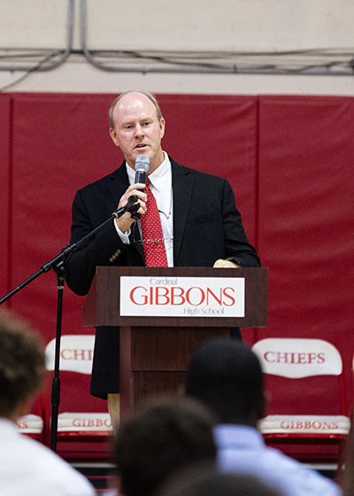 Thomas E. Mahon, president of Cardinal Gibbons High School in Fort Lauderdale, speaks to students before the start of a Mass for the opening of the new school year Aug. 22. Archbishop Thomas Wenski president at the liturgy at the school's campus.