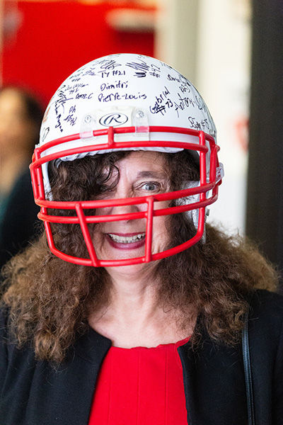 Kim Pryzbylski, superintendent of Schools for the Archdiocese of Miami, sports a special gift from members of the Cardinal Gibbons High School football team in Fort Lauderdale Aug. 22. The teammates signed a gift football helmet for the  Archbishop Thomas Wenski while area priests were given guest passes to upcoming football games.