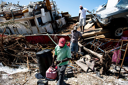 People recover items from a beached boat after Hurricane Dorian Sept. 5, 2019, in Marsh Harbor, Great Abaco.