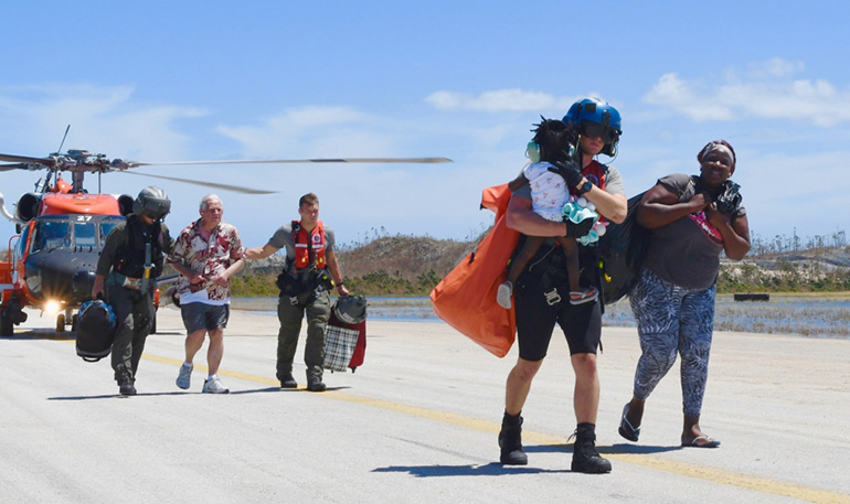 Members of the U.S. Coast Guard conduct search and rescue efforts after the passage of Hurricane Dorian in the Bahamas.