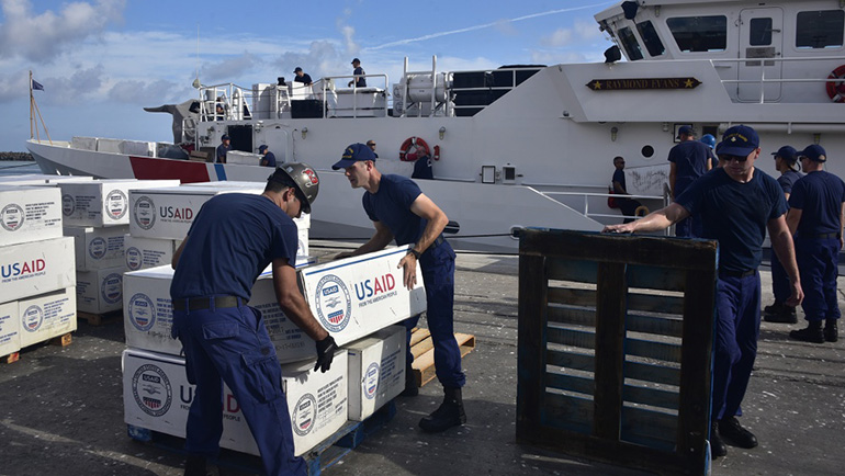 Members of the Coast Guard Cutter Raymond Evans (WPC-1110) offload boxes of supplies from the cutter Sept. 6, 2019 in Nassau, Bahamas, during Hurricane Dorian response efforts. (U.S. Coast Guard photo by Petty Officer 2nd Class Jonathan Lally)