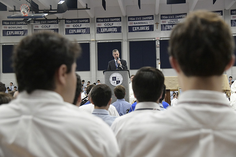 Students listen as Thomas G. Kruczek, Christopher Columbus High School's second president, pledges to "continue to serve God according to the Marist mission."