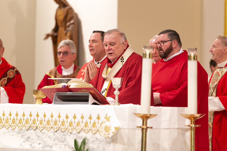 Archbishop Thomas Wenski is surrounded by concelebrating priests as he presides at the 30th annual Red Mass of the Broward County-based St. Thomas More Society of South Florida, Sept. 26 at St. Anthony Church in Fort Lauderdale. Catholic judges, lawyers and other legal professionals attended the event.