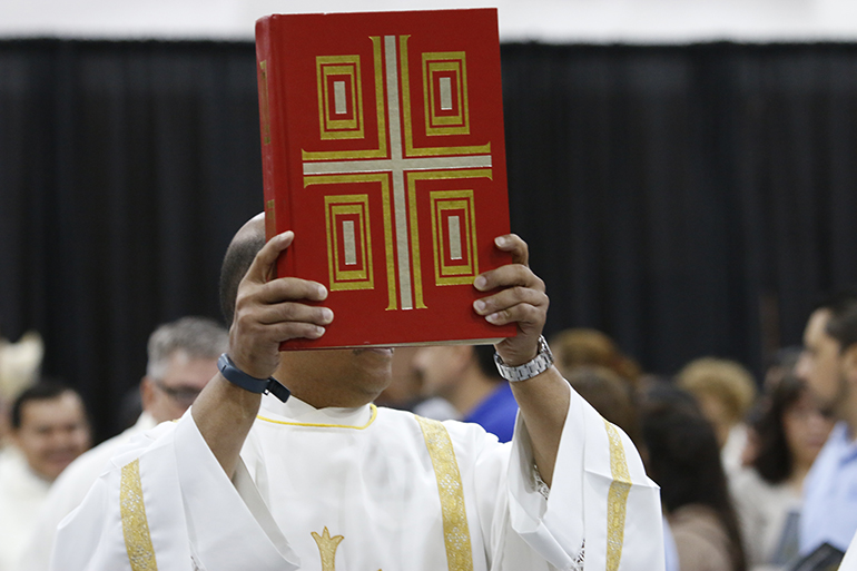 Pope Francis, in proclaiming the Sunday of the Word of God, suggested parishes should highlight the “proclamation of the word of the Lord and emphasize in the homily the honor that it is due.” In this file photo, Deacon Pierre Douyon of St. Maximilian Kolbe Parish in Pembroke Pines carries the Book of the Gospels during Mass.