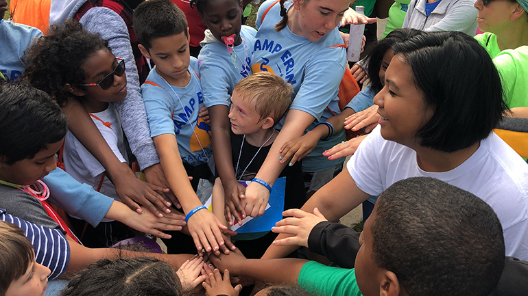 Campers and volunteers from Camp Erin gather around and place their hands in the center before a cheer. Camp Erin is a weekend long, bereavement camp sponsored by Catholic Hospice for kids and teens from 6-17, that fuses grief education with traditional camp fun. The next camp will be October 18-20 at Hugh Taylor Birch State Park in Fort Lauderdale.