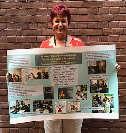 St. Jerome School teacher Wendy Lockard holds up her project on â€œTeaching the Holocaust to Middle School Teachersâ€ and â€œThe Lessons of the Holocaust to Elementary Teachers.â€ She successfully completed a Museum Teacher Fellowship at the U.S. Holocaust Memorial Museum in Washington, D.C.