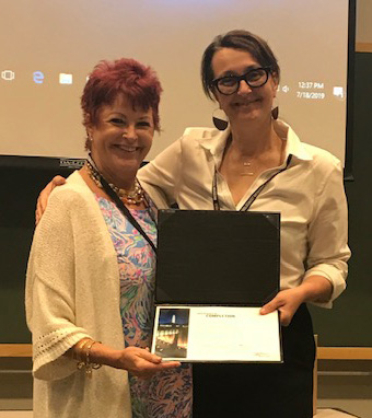 St. Jerome School teacher Wendy Lockard, left, receives her certificate as a Museum Teacher Fellow from the U.S. Holocaust Memorial Museum in Washington, D.C.