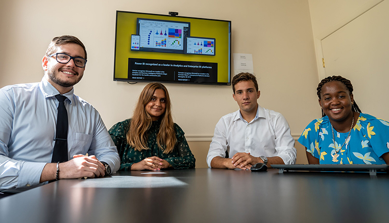 From left,  St. Thomas University students in data analytics: 
Enzo Novi Migliano, Lisa Miranda Wallje, Damian A. Etchevest, and Dekoya Hodge. The Bobcat Business Analytics Enterprises Services gives them a chance to get real work experience with local companies.