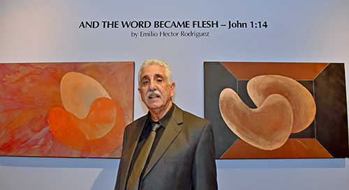 Emilio Hector Rodriguez pauses between two of his paintings -- "The Presentation in the Temple," left, and  "The Boy Jesus in the Temple" -- during the opening of his exhibit at St. Thomas University. The show, "And the Word Became Flesh," runs through Jan. 10.