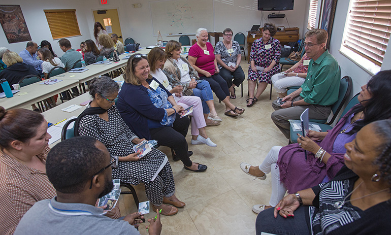 During a breakout session, participants in the bereavement ministry training look at photos and then describe what the photos mean to them during the bereavement ministry training day held at St. Agnes Church, Key Biscayne, Sept. 14.