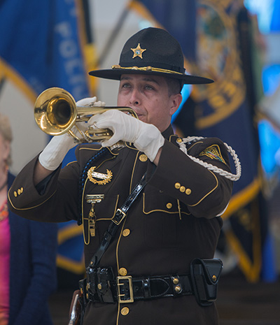 Miami Dade police officer Eduardo Gaitan, an honor guard member, plays the trumpet before the start of the Blue Mass at Our Lady of Guadalupe Church in Doral.