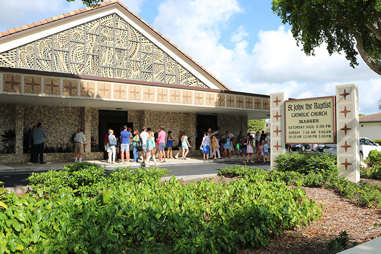 Worshipers socialize after Mass at St. John the Baptist Church, a busy hub of activity serving families and individuals living in and visiting the northeast corner of Fort Lauderdale.