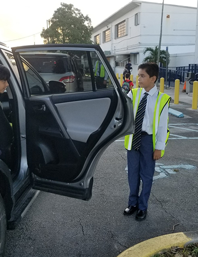 Diego Martinez, a fifth-grader at Blessed Trinity School in Miami Springs, takes his principal-for-a-day job seriously, beginning by welcoming parents, students and faculty as they arrive at the car line early in the morning.