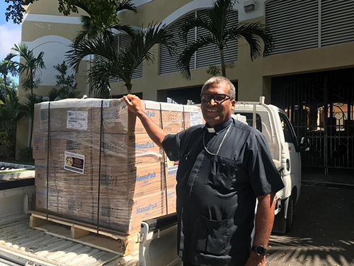 Nassau Archbishop Patrick Pinder stands by the first of two shipments of relief supplies sent by Catholic Charities of the Archdiocese of Miami to aid those recovering from Hurricane Dorian in The Bahamas. Peter Routsis-Arroyo, CEO of Catholic Charities, said, "As of now, and until Archbishop Pinder tells us his needs have changed, everything we send is shipping between Nassau, where Archbishop Pinder is working closely with the local shelters on New Providence, and Mary, Star of the Sea in Freeport, which is a major relief site."