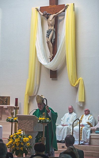 Archbishop Thomas Wenski preaches the homily during the triple anniversary Mass he celebrated at Holy Rosary-St. Richard Church Oct. 5: 60 years of Holy Rosary's establishment, 50 years of St. Richard's establishment and 30 years of the construction of St. Richard Church.