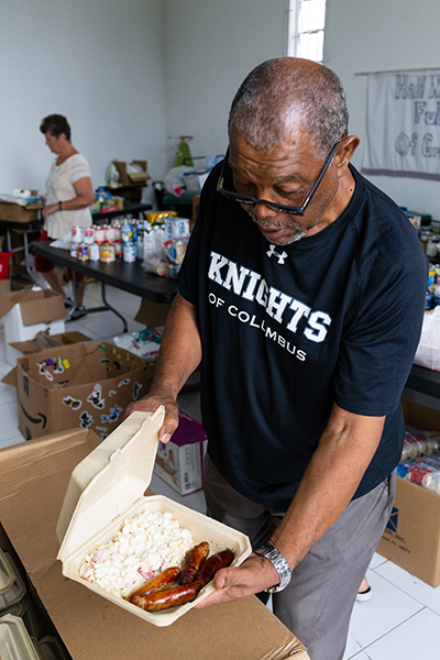 Patrick Ferguson, a retired national radio broadcaster in the Bahamas and a longtime member of Mary, Star of the Sea Parish in Freeport, prepares a hot meal for distribution Oct. 8, more than a month following Hurricane Dorian's impact in The Bahamas.