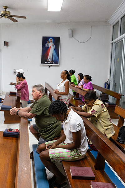 Parishioners gather for noon Mass at Mary, Star of the Sea Parish in Freeport Oct. 8, more than a month following Hurricane Dorian's impact in The Bahamas. The area was heavily damaged by Dorian's storm surge-flooding throughout Grand Bahama.