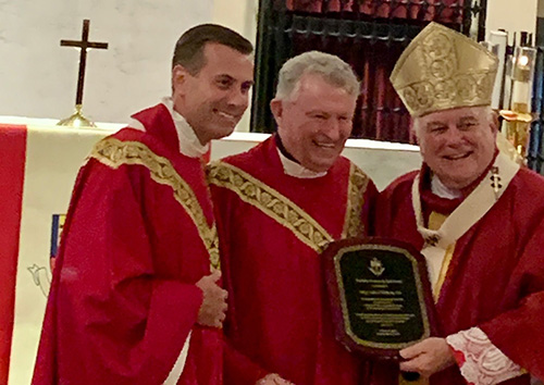Archbishop Thomas Wenski and Msgr. David Toups, left, rector of St. Vincent de Paul Regional Seminary in Boynton Beach, award the St. Vincent de Paul Award to Msgr. Jude O'Doherty, for his long years of service to the Church under Miami's four archbishops. "An exemplary priest and pastor," Archbishop Wenski said.