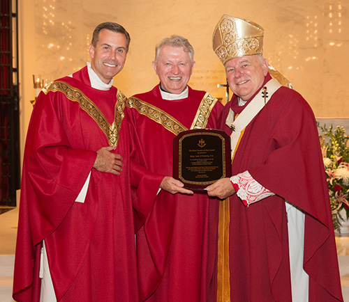Archbishop Thomas Wenski and Msgr. David Toups, left, rector of St. Vincent de Paul Regional Seminary in Boynton Beach, award the St. Vincent de Paul Award to Msgr. Jude O'Doherty, for his long years of service to the Church under Miami's four archbishops. "An exemplary priest and pastor," Archbishop Wenski said.