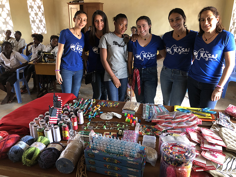 Hope for Kasai missionaries from South Florida pose with some of the donated items they brought for the sewing center in Mpiana Nita, Democratic Republic of Congo.