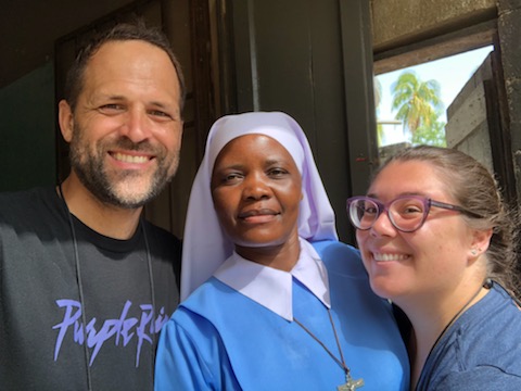 Andres Novela and another missionary from Amor en Accion pose with a sister from Haiti during a mission trip to the island nation.