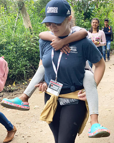 Some piggy-back fun: Mindo Futures missionary Viviana Yerex carries a friend during a mission trip in Mindo, Ecuador.