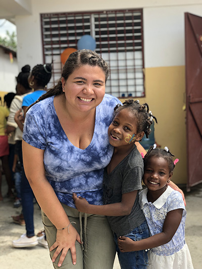 Summer 2012-2019
MIAMI

Amor en Accion missionary Orianna Cardoza gets a big hug from new friends she made during a mission trip in the Dominican Republic this summer.