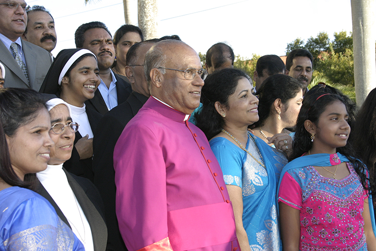 Msgr. James Parappally poses with members of the Indian Catholic community after the investiture ceremony for newly named monsignors, March 2, 2008. He was the first Indian priest to be made a monsignor in the archdiocese.