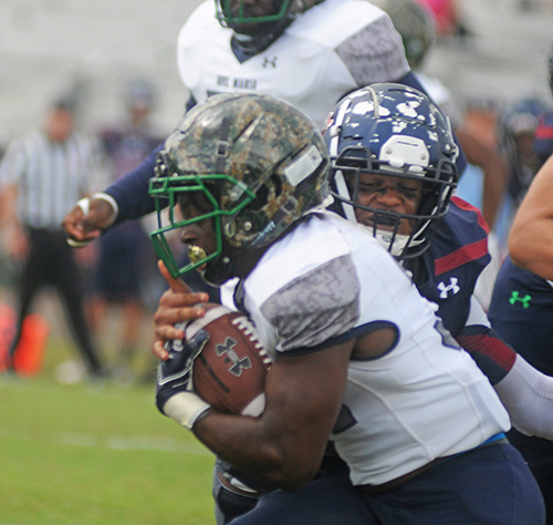 St. Thomas' Shariff Rodriguez (back) tackles Ave Maria running back Quino Mauricette during their football game on Oct. 26, 2019, at Msgr. Pace High School.