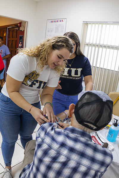 The Cuban Knights of Malta hosted a Health Fair at Our Lady of Charity National Shrine Nov. 2. Volunteers Sophia Menendez, left, and Ana Pinon from the FIU Herbert Wertheim College of Medicine gave their time and talent to aid the community.