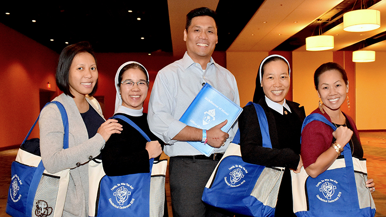 Five members of Our Lady of La Vang Vietnamese mission pause during the Catechetical Conference in Miami. From left are Jena Ho, Sister Phuong Van, Anthony Tran, Sister Quyen Nguyen, and Nhung Huynh-Kaloyios.