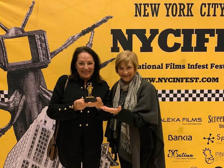 Carmen Valdivia, left, and Carmencita Romanach, of Operation Pedro Pan Group, pose with the award for best document feature film awarded by the 2019 New York City International Films Infest Festival.