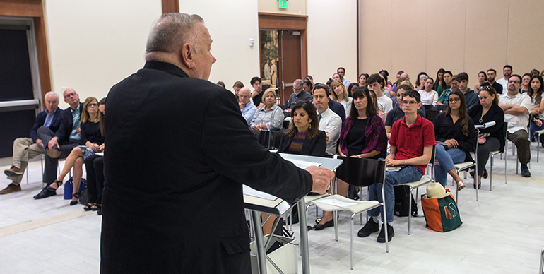 Archbishop Thomas Wenski addresses a University of Miami forum on "Who Is Our Neighbor? Immigration in Light of Catholic Social Teaching," held in the Newman Alumni Center, Oct. 21, 2019.