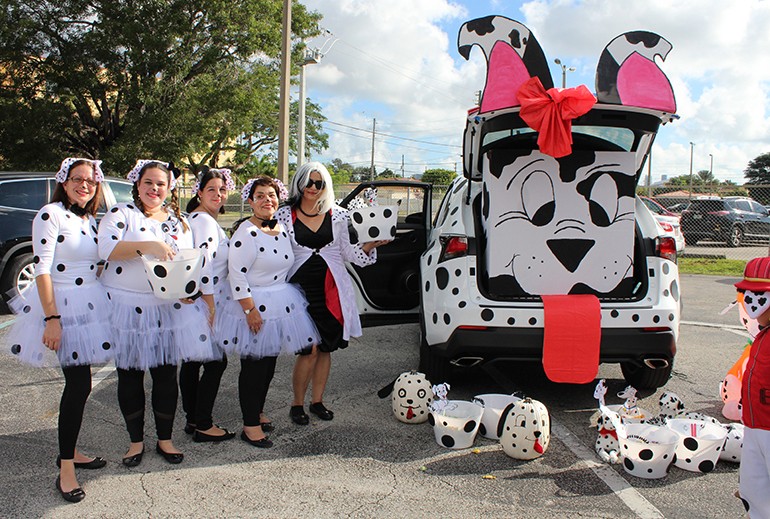 More spots than a Dalmatian: Faculty members from St. Michael the Archangel School, including school Principal Carmen Alfonso (second from right), took Disney's 101 Dalmatians quite seriously at this year's trunk or treat event Oct. 31. The entire car exterior was decked out in spots.