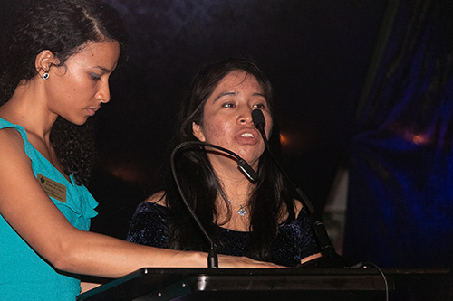 Amalia Itzep, right, who was separated from her two young sons for two months in 2018, thanks Catholic Legal Services for standing by her "when I needed them most" as the agency's Paola Bichara, an immigration specialist, prepares to translate.