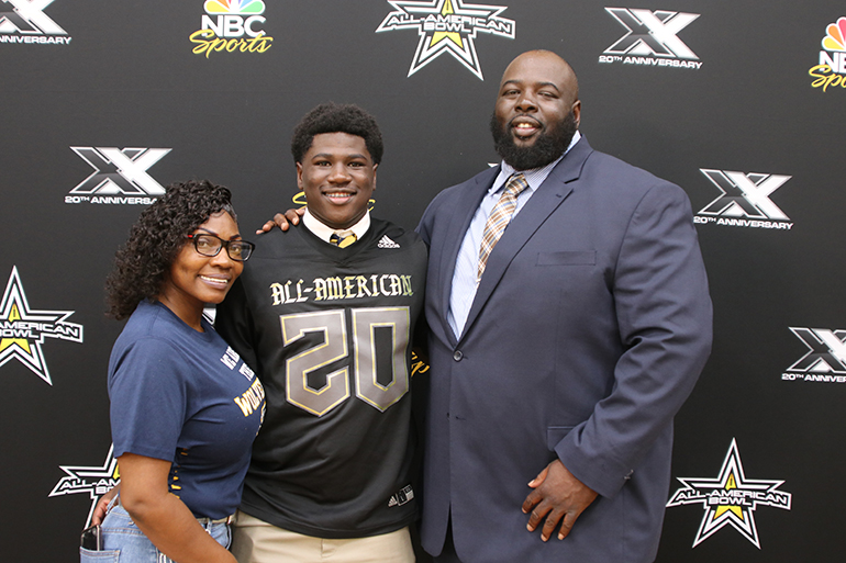 Belen Jesuit Don Chaney Jr. poses with his parents, Williesha and Don Chaney Sr., after receiving his All-American Bowl football jersey.